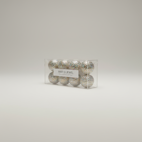 Professional e-commerce product photography of a **brandless** Mar 13 Jewel Golf Ball 12 Pack (Premium distance golf balls with a blinged-out finish for standout rounds.). The entire environment is a perfectly uniform, flat, solid color #EAE9E7 (light warm gray) with absolutely no gradient, vignette, spotlighting, texture, noise, or grain. The object is centered and tiny, occupying only 25% of the frame, surrounded by massive negative space. The background and floor are a seamless, infinite cyclorama of solid color #EAE9E7 with no horizon line, no corner, and no visible wall/floor transition. Lighting: ultra-even high-key with very strong global illumination and soft, multi-directional bounced fill (studio light tent look). Bright exposure (lifted midtones and shadows, low contrast), slightly overexposed overall while preserving product detail. Fully diffuse, no hard shadows, no cast shadows; at most a barely visible neutral contact shadow. No harsh specular highlights. Framing: simple 3/4 view. Perfectly centered. Style: ultra-clean, minimalistic. No logos, no text, no distractions. 8k resolution, sharp details on the object.